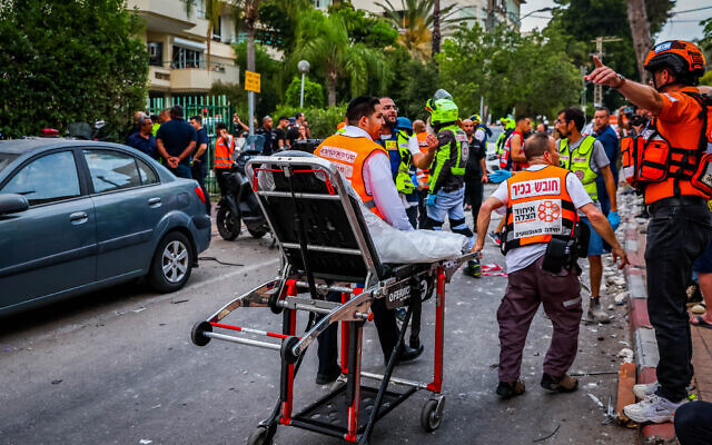 Police and rescue forces at the scene where a rocket fired from Gaza hit and damaged a house in Rehovot on May 11, 2023. Photo by (Liron Moldovan/Flash90) Police and rescue forces at the scene where a rocket fired from Gaza hit and damaged a house in Rehovot on May 11, 2023. Photo by (Liron Moldovan/Flash90)