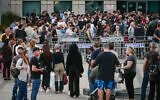 People line up outside the Interior Ministry office to renew their passports, in Tel Aviv, on May 14, 2023. (Avshalom Sassoni/FLASH90)