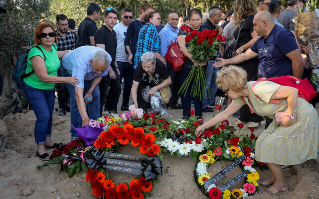 Family and friends attend the funeral of Inga Avramyan, 82, in Kibbutz Givat Brenner in southern Israel, May 15, 2023. (Jonathan Shaul/Flash90)