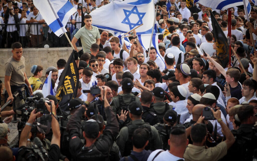 Young Jewish men hold Israeli flags and flags of the racist, far-right Lehava organization at Damascus Gate in Jerusalem's Old City, during Jerusalem Day celebrations, May 18, 2023. (Jamal Awad/Flash90) Young Jewish men hold Israeli flags and flags of the racist, far-right Lehava organization at Damascus Gate in Jerusalem's Old City, during Jerusalem Day celebrations, May 18, 2023. (Jamal Awad/Flash90)