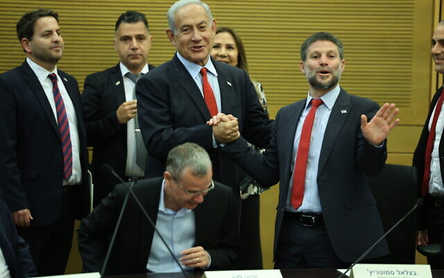 Prime Minister Benjamin Netanyahu (C) and Finance Minister Bezalel Smotrich (R) attend a press conference on the planned state budget vote, in the Knesset on May 23, 2023.(Yonatan Sindel/Flash90)