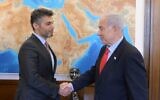 Prime Minister Benjamin Netanyahu (R) receives an invitation to the COP28 climate summit in November in Dubai from Mohamed Al Khaja, the UAE ambassador to Israel, May 25, 2023 (Amos Ben Gershom/GPO)