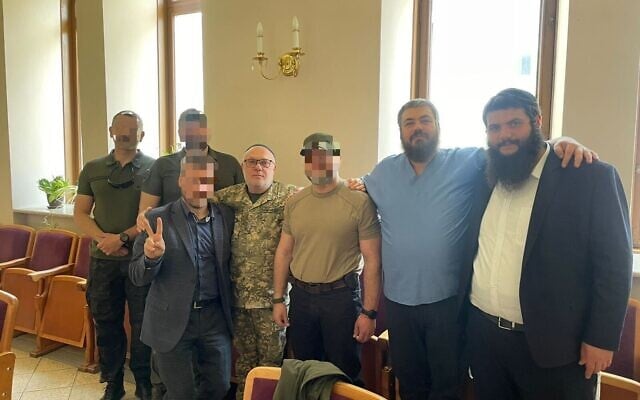 Rabbi David Milman (fourth from left) and mohel Dr. Yaakov Gaisinovich (second from right) join Ukrainian soldiers who underwent circumcisions in Kyiv, May 16, 2023 (Office of the Chief Rabbi) Rabbi David Milman (fourth from left) and mohel Dr. Yaakov Gaisinovich (second from right) join Ukrainian soldiers who underwent circumcisions in Kyiv, May 16, 2023 (Office of the Chief Rabbi)