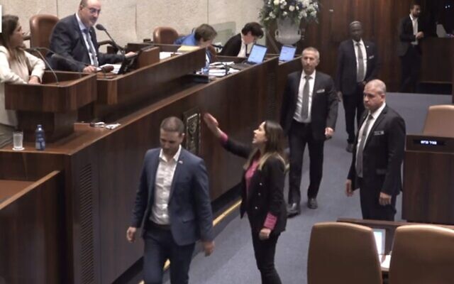 Screen capture from video of May Golan, Minister for the Advancement of Women, center-right, shouting at Yesh Atid MK Merav Ben-Ari, top-left, during a Knesset debate, May 1, 2023. (Channel 12. Used in accordance with Clause 27a of the Copyright Law) Screen capture from video of May Golan, Minister for the Advancement of Women, center-right, shouting at Yesh Atid MK Merav Ben-Ari, top-left, during a Knesset debate, May 1, 2023. (Channel 12. Used in accordance with Clause 27a of the Copyright Law)