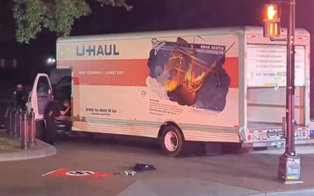 A Nazi flag is seen in front of a box truck that crashed into a security barrier at a park across from the White House in Washington, DC, May 22, 2023. (Screencapture/Twitter)
