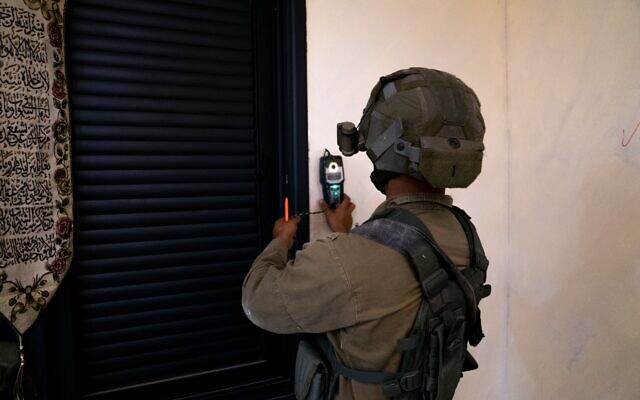 An Israeli soldier takes measurements at the home of Khaled Kharousha, accused of helping his father, a Hamas terrorist, in carrying out a deadly attack in Huwara, in the West Bank city of Nablus early May 13, 2023. (Israel Defense Forces) An Israeli soldier takes measurements at the home of Khaled Kharousha, accused of helping his father, a Hamas terrorist, in carrying out a deadly attack in Huwara, in the West Bank city of Nablus early May 13, 2023. (Israel Defense Forces)