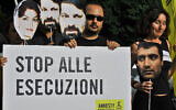 Iranian students and Amnesty International members hold a banner reading 'Stop executions' during demonstration in front of Iranian Embassy against the arrests of political leaders during post-election protests in Tehran in June 2009 (Andreas Solaro / AFP)