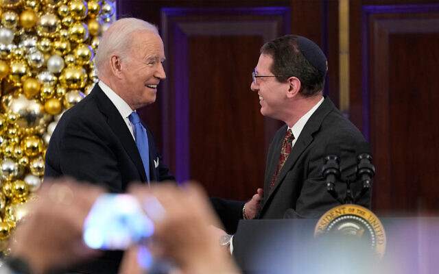 US President Joe Biden (left) greets Rabbi Charlie Cytron-Walker during a Hanukkah holiday reception in the Grand Foyer of the White House in Washington, December 19, 2022. (AP Photo/Susan Walsh) US President Joe Biden (left) greets Rabbi Charlie Cytron-Walker during a Hanukkah holiday reception in the Grand Foyer of the White House in Washington, December 19, 2022. (AP Photo/Susan Walsh)