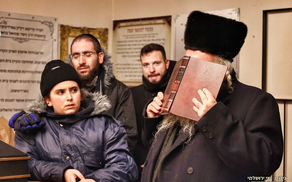 Relatives of some of the victims of the Mount Meron disaster prey in their memory during a solidarity visit with  Jews in war-torn Ukraine on Dec. 23, 2021. (Courtesy of Shimon Elhadad)