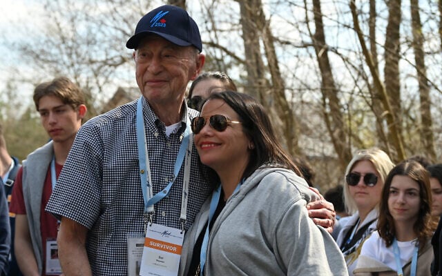 Sol Nayman hugs a participant of the March of the Living event during Nayman's first visit in 84 years to Stoczek, Poland on April 20, 2023. (Canaan Lidor/Times of Israel)