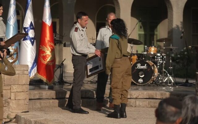 IDF chief Herzi Halevi hands a reservist soldier an award during a ceremony at the IDF headquarters in Tel Aviv, May 8, 2023. (Israel Defense Forces) IDF chief Herzi Halevi hands a reservist soldier an award during a ceremony at the IDF headquarters in Tel Aviv, May 8, 2023. (Israel Defense Forces)