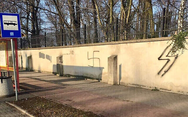 A swastika on the wall of a Jewish cemetery in Oświęcim, Poland, Jan. 10, 2021. (The Memorial and Museum Auschwitz-Birkenau via JTA) A swastika on the wall of a Jewish cemetery in Oświęcim, Poland, Jan. 10, 2021. (The Memorial and Museum Auschwitz-Birkenau via JTA)
