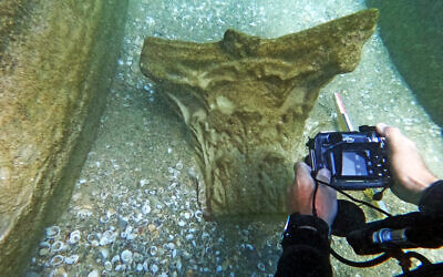 An Israel Antiquities Authority archaeologist checks out pieces of 1,800-year-old marble from a shipwreck off the shore of Beit Yanai in central Israel. (Israel Antiquities Authority's Theft Prevention Unit)