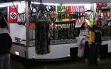 A swastika flag, left, is displayed for sale at a store at the Gladstone Harbour Festival in central Queensland, April 11, 2006. (Chris Donaghy/AAP Image via AP)