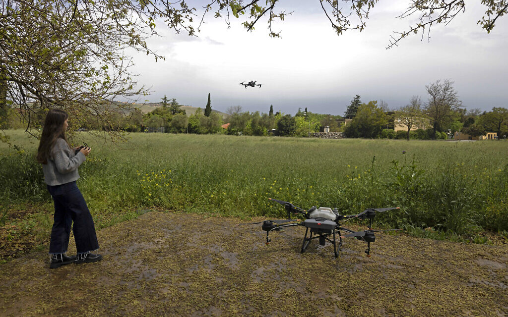 A picture taken on April 13, 2023, shows an employee of the agronomy tech company AgroScout flying a drone in the northern Israeli kibbutz of Yiron. (Menahem Kahana/AFP) A picture taken on April 13, 2023, shows an employee of the agronomy tech company AgroScout flying a drone in the northern Israeli kibbutz of Yiron. (Menahem Kahana/AFP)