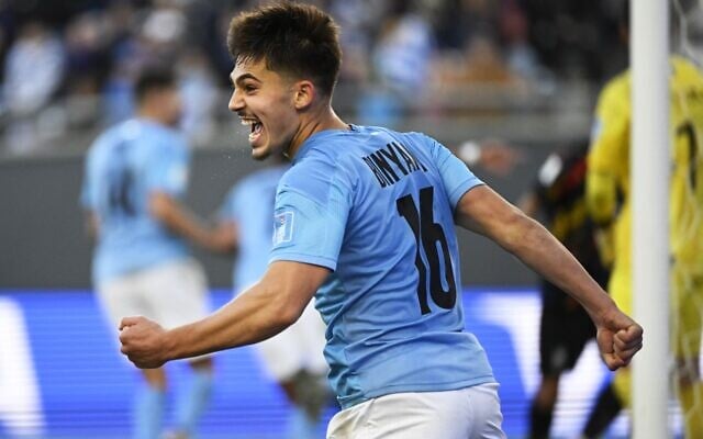 Israel's midfielder Ran Binyamin celebrates a goal scored by forward Anan Khalaili during the Argentina 2023 U-20 World Cup third-place match between Israel and South Korea at the Estadio Unico Diego Armando Maradona stadium in La Plata, Argentina, on June 11, 2023. (Luis ROBAYO / AFP)