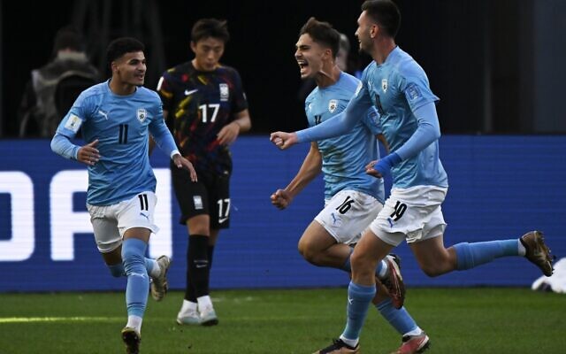 Israel's midfielder Ran Binyamin (2nd-R) celebrates with teammates defender Hadar Fuchs (R), and forward Hamza Shibli (L) after scoring a goal during the Argentina 2023 U-20 World Cup third-place match between Israel and South Korea at the Estadio Unico Diego Armando Maradona stadium in La Plata, Argentina, on June 11, 2023. (Luis ROBAYO / AFP) Israel's midfielder Ran Binyamin (2nd-R) celebrates with teammates defender Hadar Fuchs (R), and forward Hamza Shibli (L) after scoring a goal during the Argentina 2023 U-20 World Cup third-place match between Israel and South Korea at the Estadio Unico Diego Armando Maradona stadium in La Plata, Argentina, on June 11, 2023. (Luis ROBAYO / AFP)