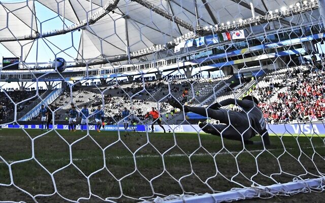 Israel's goalkeeper Ofek Melika can't keep out a goal scored by South Korea's midfielder Lee Seung-won from the penalty spot during the Argentina 2023 U-20 World Cup third-place match between Israel and South Korea at the Estadio Unico Diego Armando Maradona stadium in La Plata, Argentina, on June 11, 2023. (Luis ROBAYO / AFP)