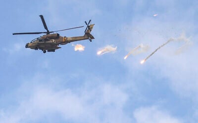 An Israeli Air Force AH-64 Apache attack helicopter releases flares during an Israeli army raid in Jenin in the West Bank on June 19, 2023. (Jaafar ASHTIYEH / AFP)