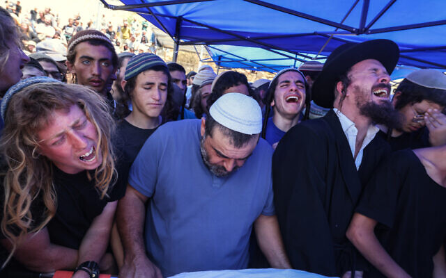 Relatives and friends mourn during the funeral of 17-year-old Nachman Mordoff, who was killed in a terror attack near the West Bank settlement of Eli, at the cemetery in Shilo, on June 21, 2023. (Photo by Menahem KAHANA / AFP) Relatives and friends mourn during the funeral of 17-year-old Nachman Mordoff, who was killed in a terror attack near the West Bank settlement of Eli, at the cemetery in Shilo, on June 21, 2023. (Photo by Menahem KAHANA / AFP)