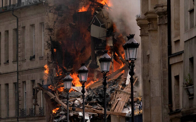 Smoke billows from rubbles of a building at Place Alphonse-Laveran in the 5th arrondissement of Paris, on June 21, 2023.  (Photo by ABDULMONAM EASSA / AFP)