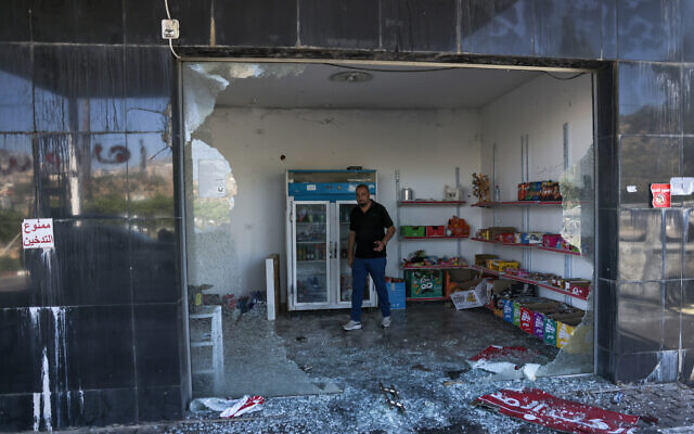 A man checks the convenience store of a gas station, reportedly vandalized by settlers, in al-Lubban al-Sharqiya in the West Bank on June 21, 2023. (AHMAD GHARABLI / AFP) A man checks the convenience store of a gas station, reportedly vandalized by settlers, in al-Lubban al-Sharqiya in the West Bank on June 21, 2023. (AHMAD GHARABLI / AFP)