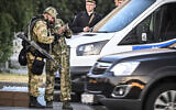 Russian soldiers and police officers stand an the edge one of the highways entering Moscow on June 24, 2023. (Alexander Nemenov/AFP)