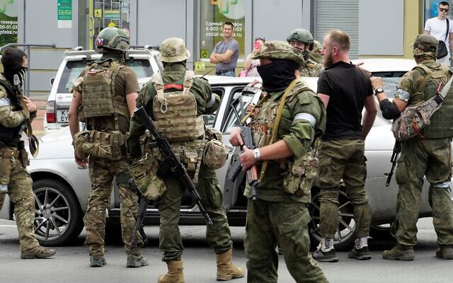 Members of Wagner Group inspect a car in a street of Rostov-on-Don, on June 24, 2023. (Stringer/AFP) Members of Wagner Group inspect a car in a street of Rostov-on-Don, on June 24, 2023. (Stringer/AFP)