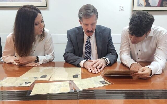 Eli Rosenbaum, center, former director of the US Justice Department’s Office of Special Investigations presents officials at Israel's Justice Ministry with documents used in the trial of Nazi wartime camp guard John Demjanjuk, June 2023. (Justice Ministry)