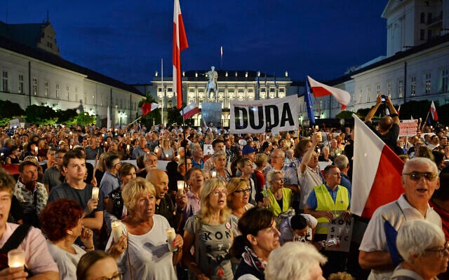 File: Protesters shout slogans as they gather in front of the Presidential Palace to show President Andrzej Duda their disapproval after he signed controversial legislation on the Supreme Court into law, in Warsaw, Poland, July 26, 2018. (AP Photo/Alik Keplicz) File: Protesters shout slogans as they gather in front of the Presidential Palace to show President Andrzej Duda their disapproval after he signed controversial legislation on the Supreme Court into law, in Warsaw, Poland, July 26, 2018. (AP Photo/Alik Keplicz)