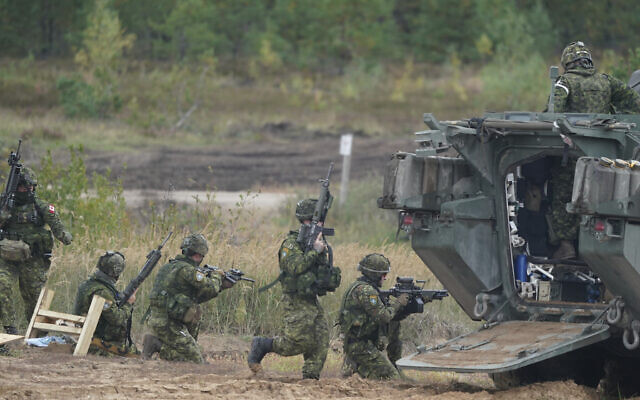 Canadian soldiers attend the NATO military exercises at a training ground in Kadaga, Latvia, on September 13, 2021. (Roman Koksarov/AP) Canadian soldiers attend the NATO military exercises at a training ground in Kadaga, Latvia, on September 13, 2021. (Roman Koksarov/AP)
