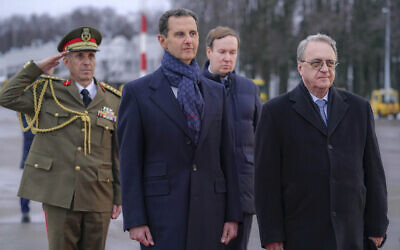 File - Visiting Syrian President Bashar Assad, left, and Mikhail Bogdanov, right, deputy minister of Foreign Affairs of Russia and Special Representative of the President of Russia for the Middle East, review an honor guard during a welcome ceremony upon Assad's arrival at Vnukovo airport in Moscow, Russia, March 14, 2023. (SANA via AP)
