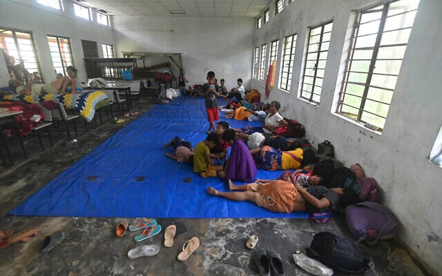 Refugees from Manipur rest in the northeastern Indian state of Assam, Sunday, May 7, 2023. (AP Photo/Panna Ghosh)