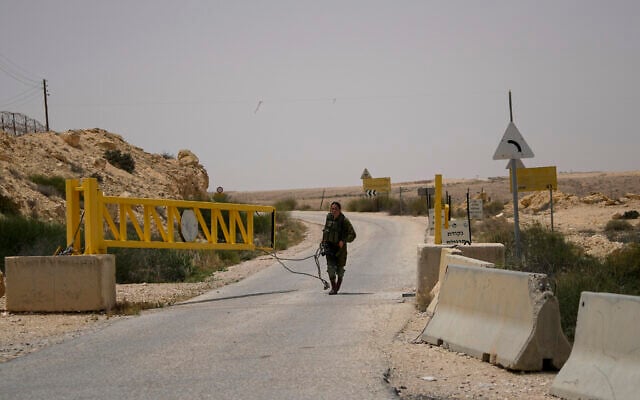 An Israeli soldier closes a gate leading to the Egyptian border in southern Israel, following a shooting attack on June 3, 2023. (AP/Tsafrir Abayov) An Israeli soldier closes a gate leading to the Egyptian border in southern Israel, following a shooting attack on June 3, 2023. (AP/Tsafrir Abayov)