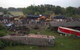 Workers at the site of a deadly train derailment, in Balasore district, in the eastern Indian state of Orissa, June 4, 2023. (AP Photo/Rafiq Maqbool)