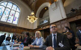 Ukraine's delegation with ambassador-at-large of the ministry of foreign affairs Anton Korynevych, right, and director general of international law of the ministry of foreign affairs Oksana Zolotaryova, second right, wait for judges to enter the World Court in The Hague, Netherlands, June 6, 2023. (AP Photo/Peter Dejong)