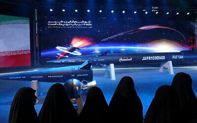 Women look at Fattah missile in a ceremony in Tehran, Iran, Tuesday, June 6, 2023. Iran is claiming that it has created a hypersonic missile capable of traveling at 15 times the speed of sound. (Hossein Zohrevand/Tasnim News Agency via AP)