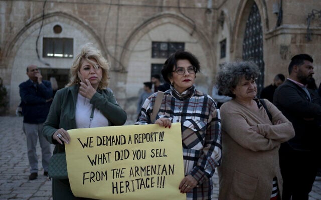 Members of the Armenian community protest a contentious deal to hand over a large section of the Armenian Quarter in the Old City of Jerusalem for a hotel project, May 19, 2023. (Maya Alleruzzo/AP) Members of the Armenian community protest a contentious deal to hand over a large section of the Armenian Quarter in the Old City of Jerusalem for a hotel project, May 19, 2023. (Maya Alleruzzo/AP)