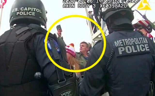 This image from Washington Metropolitan Police Department body-worn video, released and annotated by the Justice Department in the statement of facts supporting an arrest warrant for Jay James Johnston, shows Johnston, circled in yellow, at the US Capitol on January 6, 2021, in Washington. (Justice Department via AP) This image from Washington Metropolitan Police Department body-worn video, released and annotated by the Justice Department in the statement of facts supporting an arrest warrant for Jay James Johnston, shows Johnston, circled in yellow, at the US Capitol on January 6, 2021, in Washington. (Justice Department via AP)