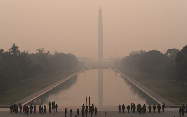 With the Washington Monument in the background and a thick layer of smoke, Marine Corps honor color guard rehearse, Thursday, June 8, 2023, in Washington (AP Photo/Jose Luis Magana) With the Washington Monument in the background and a thick layer of smoke, Marine Corps honor color guard rehearse, Thursday, June 8, 2023, in Washington (AP Photo/Jose Luis Magana)