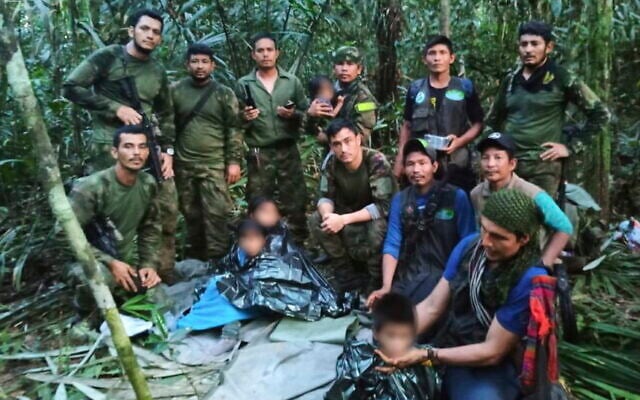 In this photo released by Colombia's Armed Forces Press Office, soldiers and Indigenous men pose for a photo with the four Indigenous brothers who were missing after a deadly plane crash, in the Solano jungle, Caqueta state, Colombia, June 9, 2023. (Colombia's Armed Force Press Office via AP) In this photo released by Colombia's Armed Forces Press Office, soldiers and Indigenous men pose for a photo with the four Indigenous brothers who were missing after a deadly plane crash, in the Solano jungle, Caqueta state, Colombia, June 9, 2023. (Colombia's Armed Force Press Office via AP)