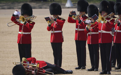 A trombone player in the military band faints during the Colonel's Review, the final rehearsal of the Trooping the Colour, the King's annual birthday parade, at Horse Guards Parade in London, June 10, 2023. (Jonathan Brady/PA via AP)
