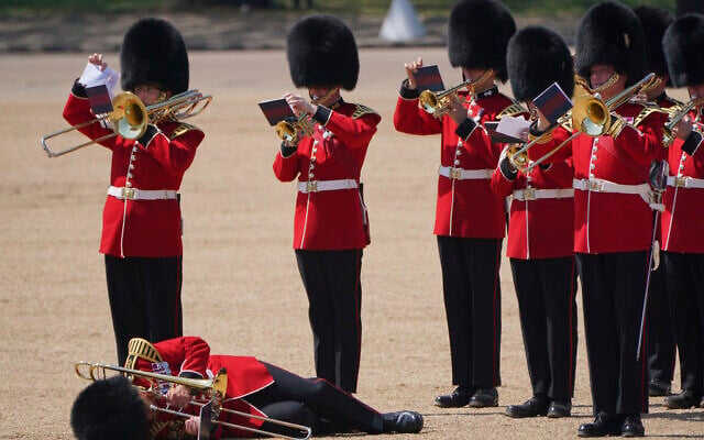 A trombone player in the military band faints during the Colonel's Review, the final rehearsal of the Trooping the Colour, the King's annual birthday parade, at Horse Guards Parade in London, June 10, 2023. (Jonathan Brady/PA via AP) A trombone player in the military band faints during the Colonel's Review, the final rehearsal of the Trooping the Colour, the King's annual birthday parade, at Horse Guards Parade in London, June 10, 2023. (Jonathan Brady/PA via AP)