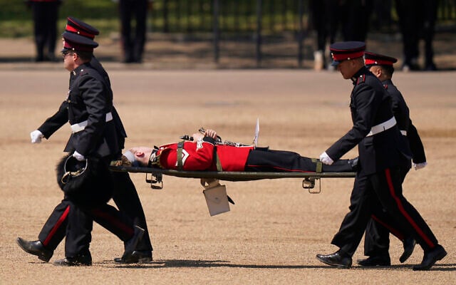 A trombone player of the military band is carried out on a stretcher after fainting during the Colonel's Review, the final rehearsal of the Trooping the Colour, the King's annual birthday parade, at Horse Guards Parade in London, June 10, 2023. (AP Photo/Alberto Pezzali) A trombone player of the military band is carried out on a stretcher after fainting during the Colonel's Review, the final rehearsal of the Trooping the Colour, the King's annual birthday parade, at Horse Guards Parade in London, June 10, 2023. (AP Photo/Alberto Pezzali)
