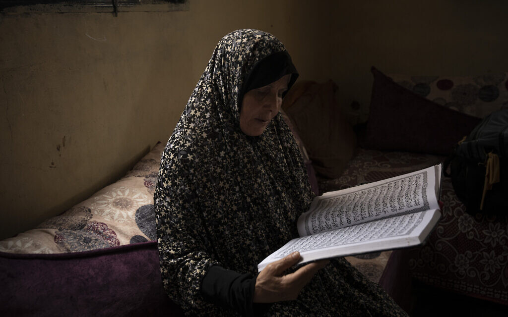 Huda Zaqqout reads from a large copy of a Muslim holy book at her home, a few weeks before she is slated to travel to Mecca for the Muslim pilgrimage of hajj, in Gaza City, May 31, 2023. (AP Photo/Fatima Shbair) Huda Zaqqout reads from a large copy of a Muslim holy book at her home, a few weeks before she is slated to travel to Mecca for the Muslim pilgrimage of hajj, in Gaza City, May 31, 2023. (AP Photo/Fatima Shbair)