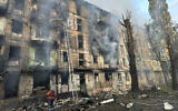In this photo released by Dnipro Regional Administration, emergency workers extinguish a fire after missiles hit a multi-story apartment building in Kryvyi Rih, Ukraine, June 13, 2023. (Dnipro Regional Administration via AP)