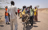 People cross the border from Sudan to South Sudan at the Joda border crossing in South Sudan on May 16, 2023. (AP Photo/Sam Mednick, file)