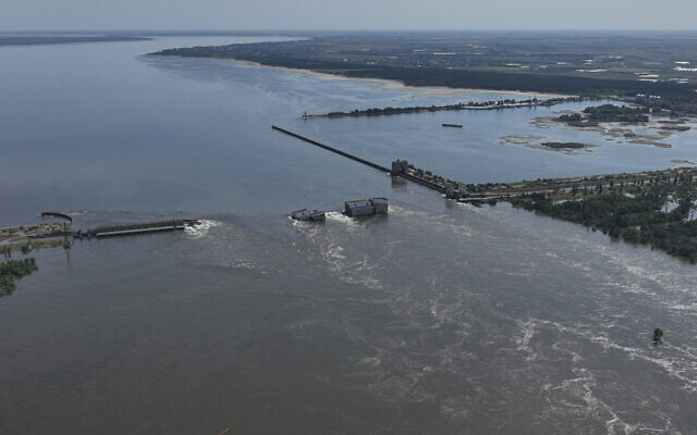 Water flows over the collapsed Kakhovka Dam in Nova Kakhovka, in Russian-occupied Ukraine, June 7, 2023. (AP Photo)