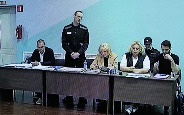 A TV Screen showing Russian opposition leader Alexei Navalny, 2nd left, between his lawyers in a courtroom, via video link provided by the Russian Federal Penitentiary Service, during a preliminary hearing, in Melekhovo, Vladimir region, Russia, June 19, 2023. (AP Photo/Alexander Zemlianichenko) A TV Screen showing Russian opposition leader Alexei Navalny, 2nd left, between his lawyers in a courtroom, via video link provided by the Russian Federal Penitentiary Service, during a preliminary hearing, in Melekhovo, Vladimir region, Russia, June 19, 2023. (AP Photo/Alexander Zemlianichenko)