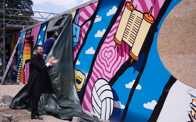 Rabbi Yehuda Teichtal attends the unveiling of a graffiti wall at the entrance of the new Jewish educational and cultural complex in Berlin, Germany, June 12, 2023. (AP Photo/Markus Schreiber)